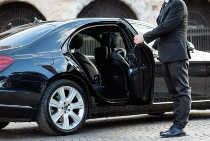 a man opening the door of a car